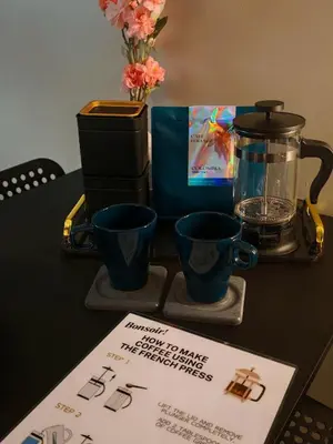 a table with two blue cups and a coffee maker at Self check-in Spacious 1BR near Airport NAIA T3, Mall of Asia in Manila