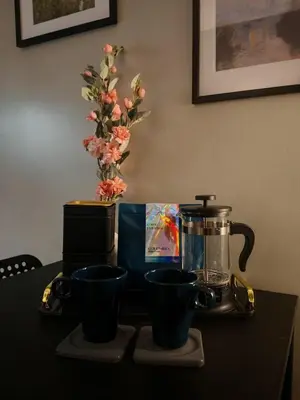 a table with two cups and a blender and flowers at Self check-in Spacious 1BR near Airport NAIA T3, Mall of Asia in Manila