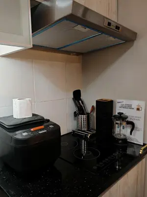 a kitchen with a counter top with a coffee maker at Self check-in Spacious 1BR near Airport NAIA T3, Mall of Asia in Manila