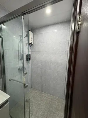 a shower with a glass door in a bathroom at Sy bay suites Near Ayala mall PITX DFA T3T2 Okada MSV2106 in Manila