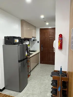 a kitchen with a stainless steel refrigerator and a counter at Sy bay suites Near Ayala mall PITX DFA T3T2 Okada MSV2106 in Manila