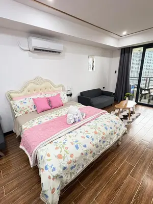 a bedroom with a large bed with a pink comforter at Sy bay suites near PITX NAIA Airport T3 MOA Okada MSV2107 in Manila