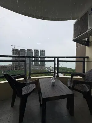 a table and chairs on a balcony with a view at Sy bay suites near PITX NAIA Airport T3 MOA Okada MSV2107 in Manila