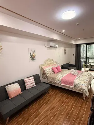 a bedroom with a bed and a couch at Sy bay suites near PITX NAIA Airport T3 MOA Okada MSV2107 in Manila