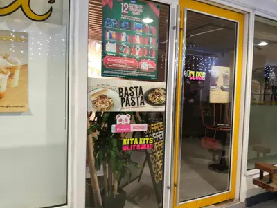 a fast food restaurant with signs on the door at Queen Pia Condotel in Manila