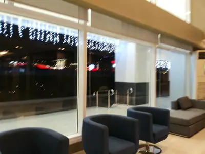 a living room with a couch and a large window at Queen Pia Condotel in Manila