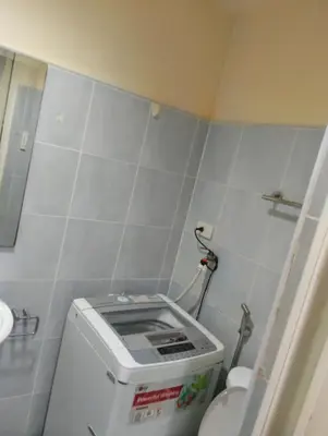 a small bathroom with a toilet with a tank at Queen Pia Condotel in Manila