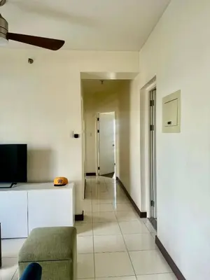 a living room with a couch and a tv at Vacation at Munti in Manila