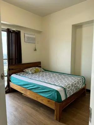a bedroom with a bed in a room at Vacation at Munti in Manila
