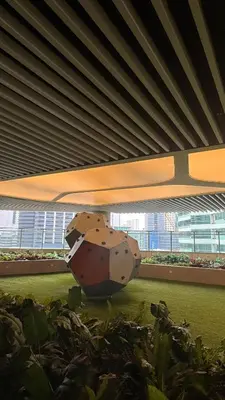 a large rock in the middle of a garden at Snooze & Stay in Manila