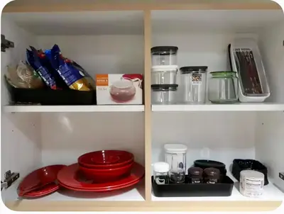 a refrigerator filled with red dishes and other kitchen items at Entire 2BR apartment in BGC in Manila