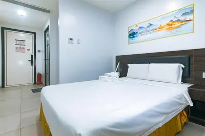 a bedroom with a large white bed in a room at Luna Hotel by RedDoorz near MOA in Manila