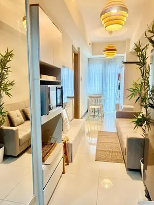 a living room with a couch and a tv at 1 Bedroom Near Mall of Asia in Manila