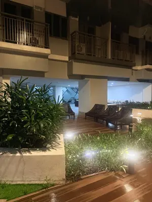a balcony of a building at night with lights at 1 Bedroom Near Mall of Asia in Manila