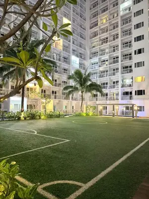 an empty basketball court in front of a large building at MC Haven Staycation near MOA in Manila