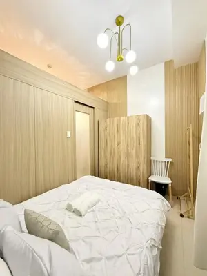 a bedroom with a large white bed in it at MC Haven Staycation near MOA in Manila