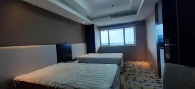 a hotel room with two beds and a window at Shell Residences Condominium Philippines, Manila, Pasay City in Manila
