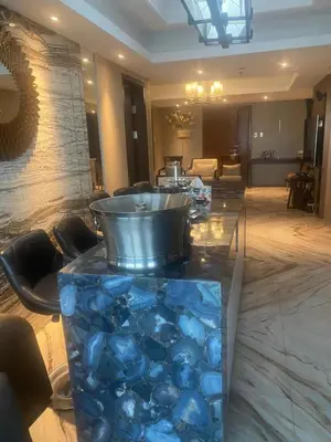 a lobby with a table with blue rocks on it at Shell Residences Condominium Philippines, Manila, Pasay City in Manila