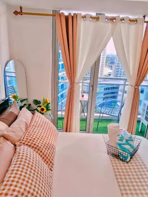 a bedroom with a bed and a large window at Vacation in Harmony in Manila