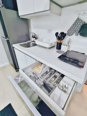 a kitchen with a sink and an open refrigerator at Vacation in Harmony in Manila