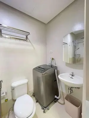 a bathroom with a toilet and a sink at Transient Home Lancin in Manila
