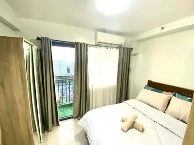 a bedroom with a bed with a teddy bear on it at Jay's Staycation at Shore Residences Pasay in Manila
