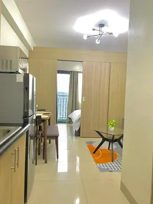 a kitchen and dining room with a table and a room at Jay's Staycation at Shore Residences Pasay in Manila