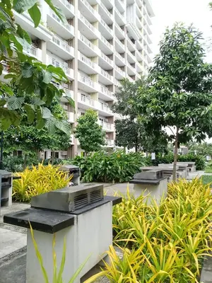 a large apartment building with trees and plants at The Atherton Condominium 1 Bedroom Staycation in Manila