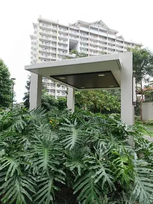 a large building behind a bunch of plants at The Atherton Condominium 1 Bedroom Staycation in Manila