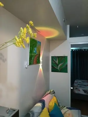 a living room with a couch and a lamp at The Atherton Condominium 1 Bedroom Staycation in Manila