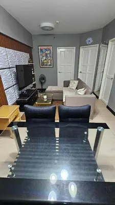 a living room with a couch and a table at Condotels by Macobs in Manila