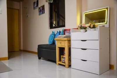 a living room with a dresser and a desk at CLBC Residences New home in the heart of Laguna in Biñan