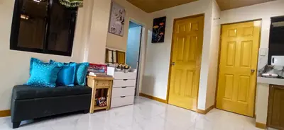 a living room with a couch and a yellow door at CLBC Residences New home in the heart of Laguna in Biñan