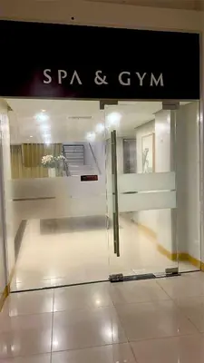 a glass door in a store with a sign on it at Elegant Central 1BR BGC 11P Uptown Parksuites T2 in Manila