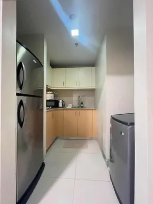 a kitchen with a stainless steel refrigerator and a dishwasher at Elegant Central 1BR BGC 11P Uptown Parksuites T2 in Manila