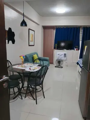a living room with a table and a couch at Neri Ann's Comfort Escape in Manila