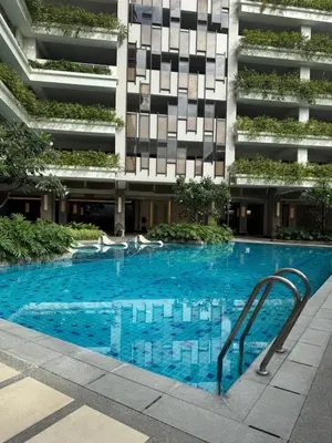 a swimming pool in front of a building at Midhaven Suite in Manila