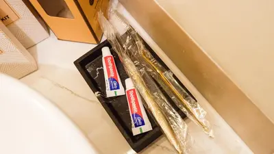 two toothbrushes in a box on a counter at Midhaven Suite in Manila