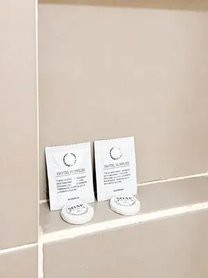 two boxes sitting on a shelf in a bathroom at Midhaven Suite in Manila