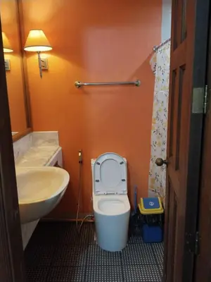 a bathroom with a white toilet and a sink at Manila Southwoods Manor in Carmona