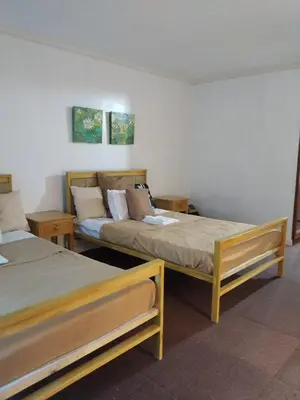 a room with two beds in a room at Manila Southwoods Manor in Carmona