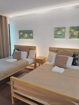 a living room with two beds and a table at Manila Southwoods Manor in Carmona
