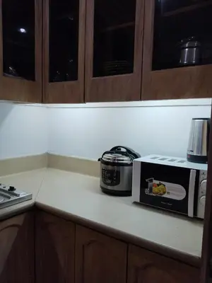 a microwave sitting on a counter in a kitchen at Manila Southwoods Manor in Carmona