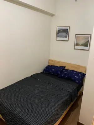 a small bedroom with a bed in a room at 2BR 38th flr SIESTA SPACE in PRISMA Residences in Manila