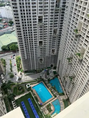 an overhead view of two tall buildings with pools at 2BR 38th flr SIESTA SPACE in PRISMA Residences in Manila