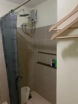 a bathroom with a shower with a shower curtain at 2BR 38th flr SIESTA SPACE in PRISMA Residences in Manila
