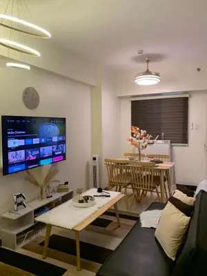 a living room with a couch and a table at 2BR 38th flr SIESTA SPACE in PRISMA Residences in Manila