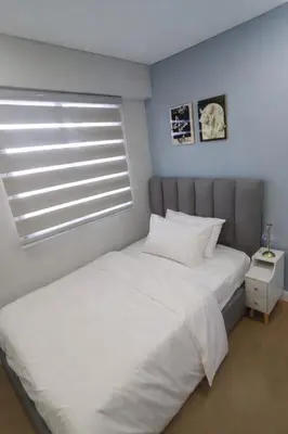 a bedroom with a white bed and a window at Casa Alea Serenity by TinTan - Cozy 3BR Condo Unit in Manila