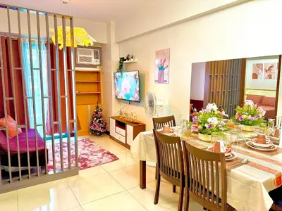 a dining room with a table and a room with at 1 Bedroom Unit terminal 3 Airport By ASD Condotel in Manila