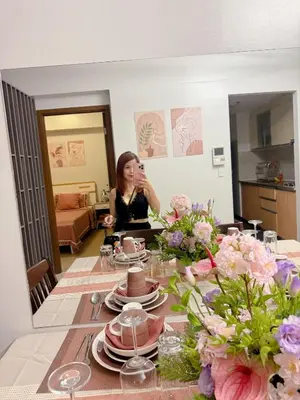 a woman taking a picture of a table with plates at 1 Bedroom Unit terminal 3 Airport By ASD Condotel in Manila